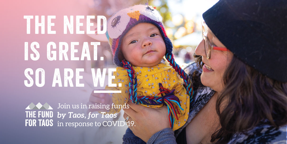 The Fund For Taos A woman holding a baby next to some text.
